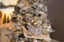 a rustic glam Christmas tree decorated with burlap, a vine deer head, wooden signs, stick snowflake ornaments and gold touches