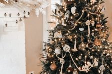a stylish boho Christmas tree with lights, tassels, boho ornaments, chalkboard ones and some deer