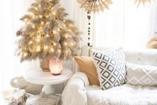 a tabletop pampas grass Christmas tree with lights is a cool and chic idea for a boho space, it looks natural and pretty