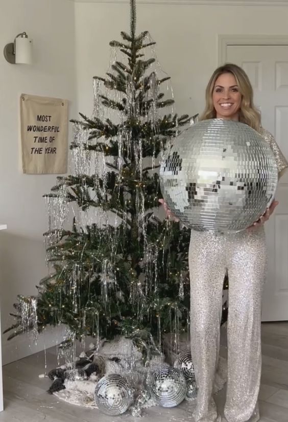 a 70s inspired Christmas tree decorated with only silver fringe and some disco balls is awesome