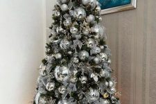 03 a Christmas tree completely covered with disco balls and silver ribbons plus lights is amazing for a NYE party