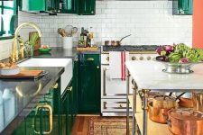 03 a bold emerald kitchen is made more eye-catchy with brass handles and a white tile backsplash