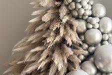 04 a jaw-dropping Christmas tree composed of pampas grass and silver ornaments plus some silver disco balls at the base