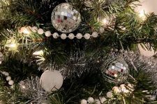 08 NYE Christmas tree decor with white, silver and disco ball ornaments, lights and bead garlands
