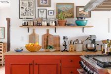 09 a bold red kitchen of only lower cabinets, a shelf, a gallery wall and some potted plants is a cool idea