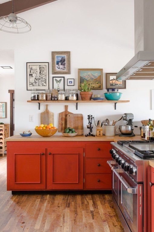 a bold red kitchen of only lower cabinets, a shelf, a gallery wall and some potted plants is a cool idea