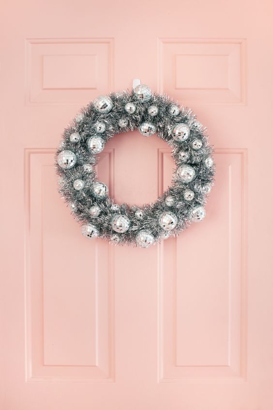 a silver Christmas wreath of tinsel and disco balls is an awesome decoration for your front door