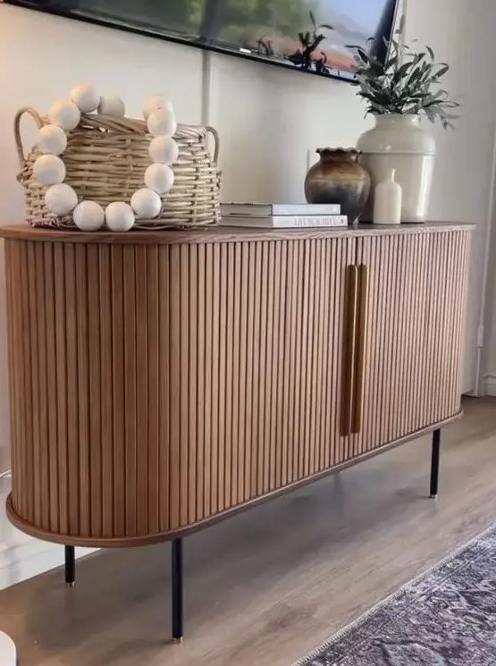 a cool rounded sideboard with fluted appearance and handles, on tall legs is a lovely idea for a modern space