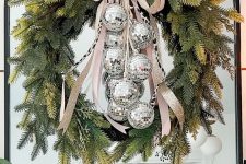 10 a pretty bright New Year decoration of an evergreen wreath and silver disco balls is a cool and catchy decoration to rock