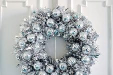 14 a gorgeous silver Christmas wreath of tinsel and disco balls is a stylish and catchy decoration