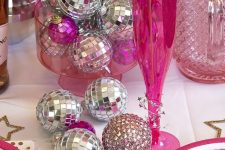 16 a bold pink and silver NYE party table with lots of disco balls is a cool and fun idea for the holiday parties