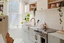 19 a stylish mid-century modern kitchen with olive green and blonde wood cabinetry, with a skinny tile backsplash and white countertops