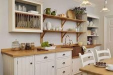 21 a white one wall farmhouse kitchen with butcherblock countertops, open shelves and box shelves is cozy