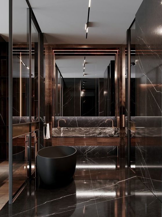 A jaw dropping chocolate brown marble bathroom with a large mirror, a black soak tub and a shower space