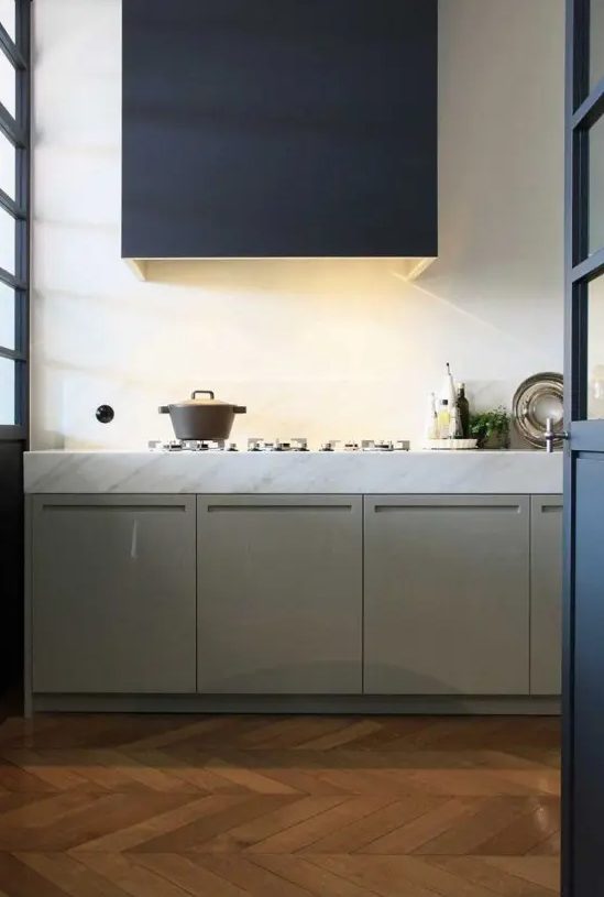 an olive green kitchen with only lower cabinets, a graphite grey hood with light is a cool idea