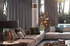 26 an exquisite taupe living room with taupe sofas and curtains, a brown rug, a glass and metal coffee table and a gorgeous chandelier