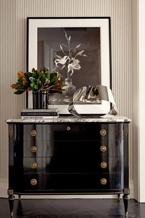 a beautiful black lacquer sideboard with a marble tabletop and refined knobs and legs is a cool and chic idea