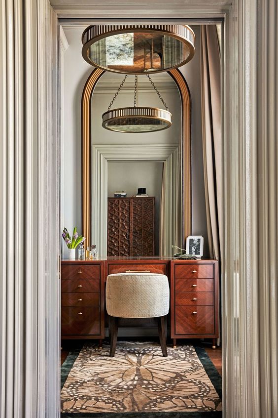 a beautiful vintage rich-stained lacquer vanity and a large mirror are a lovely combo for a vintage or refined space