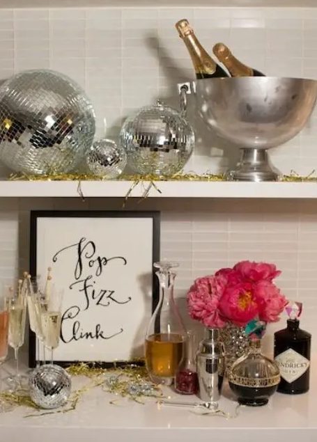 silver disco balls and bold pink blooms plus gold tinsel will make your NYE party fun, bold and cool