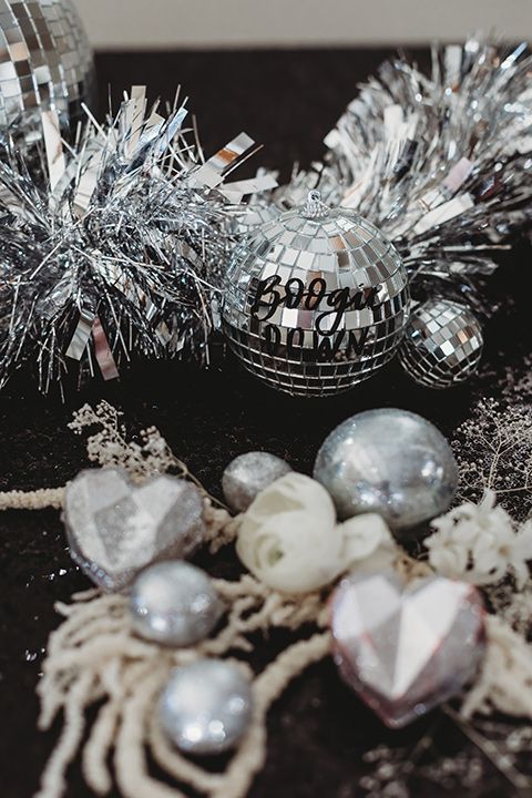 silver table decor with tinsel, disco balls and ornaments is always a good idea for the holidays