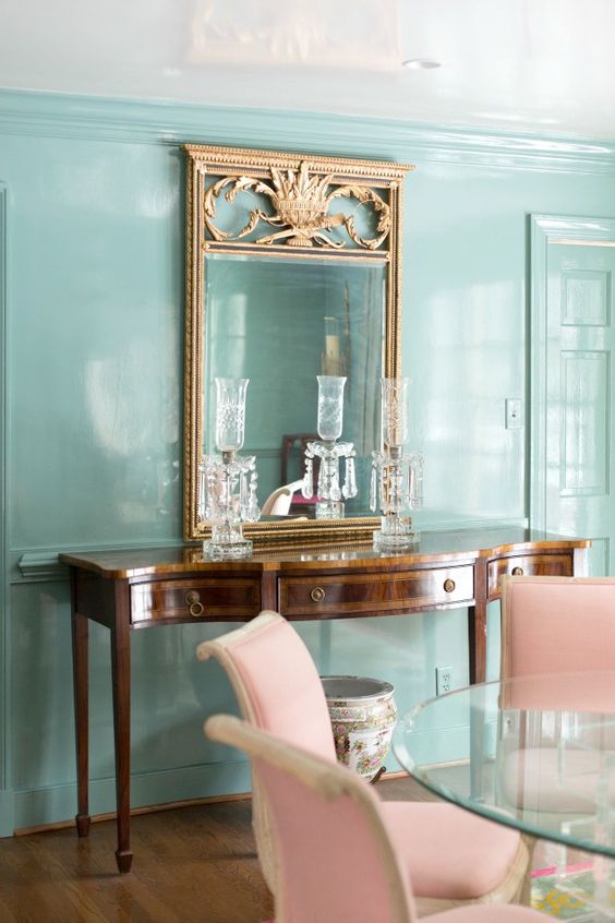 a vintage dark-stained lacquer console table with crystal candleholders is amazing for chic spaces