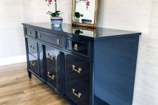 31 a navy lacquered sideboard with chic fixtures, a potted orchid and a mirror is a lovely addition