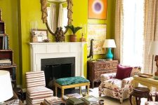 35 an eclectic chartreuse living room with a fireplace, a couple of sofas, a coffee table and stools and some decor