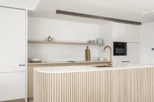 a modern kitchen with a fluted kitchen island