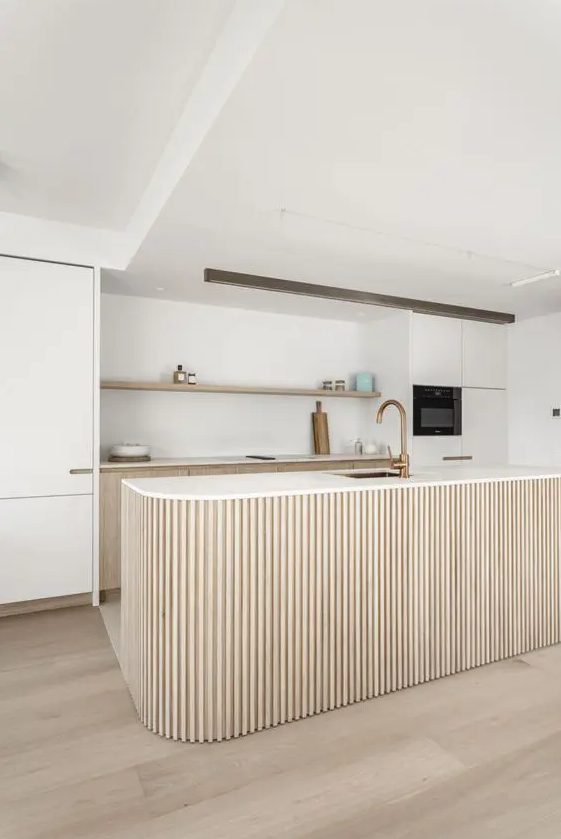 a chic neutral kitchen with stained and creamy cabinets, an open shelf, a curved and ribbed kitchen island