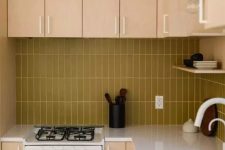 37 a light colored plywood kitchen with a mustard stacked tile backsplash and white fixtures for a fresh touch