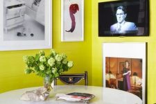 38 a bright dining nook with chartreuse walls, a round table and mismatching chairs, a corner gallery wall