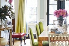 39 an exquisite dining room with a table, green chairs, chartreuse curtains, a printed rug, red chairs and some plants