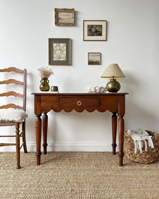 a refined rich-stained console table with a scallop edge and vintage legs as an antique find for a space