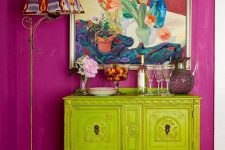 an eclectic space with a fuchsia accent wall