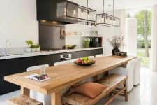 48 a contemporary kitchen is highlighted with a rustic wooden kitchen island, which is also a dining table