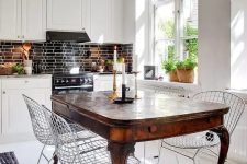 49 an antique dark stained dining table and metal chairs that create a bold contrast