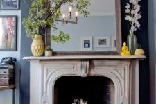 50 a vintage white stone fireplace is used for book and magazine storage, which is stylish and unexpected