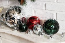 NYE mantel styling with silver, dark green and red disco balls is a super easy and cool idea for the holidays