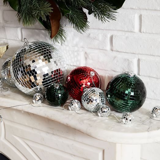 NYE mantel styling with silver, dark green and red disco balls is a super easy and cool idea for the holidays
