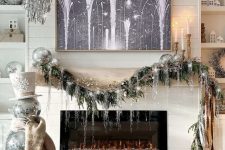 NYE party decor with silver tinsel chandeliers, a disco ball snowman and a garland with disco balls and silver fringe