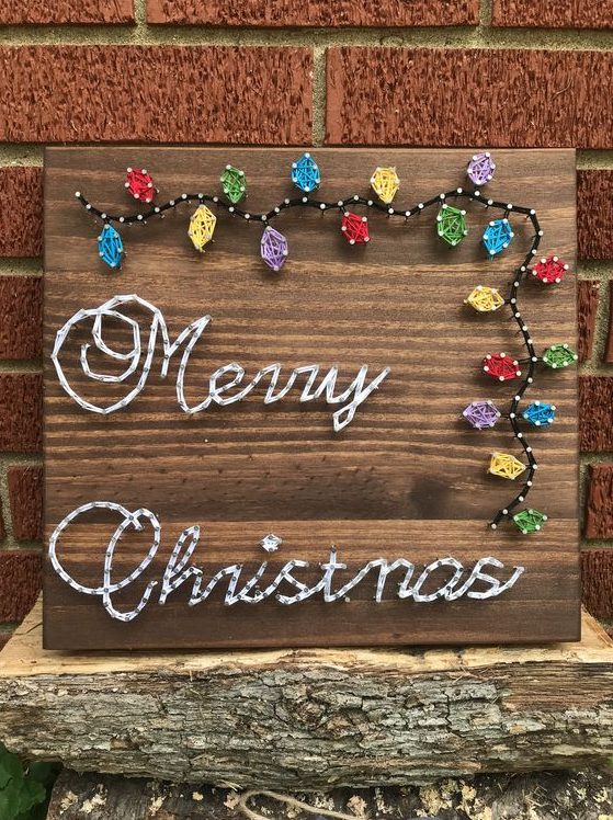 a Christmas string art piece with calligraphy and colorful lights is a cool decor idea for the holidays