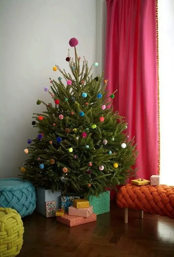 a Christmas tree decorated with colorful pompoms all over is a very fun and cool idea that won't cost you anything