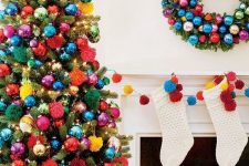 a Christmas tree decorated with super bold ornaments and pompoms plus lights is amazing