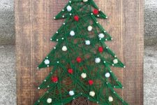 a Christmas tree string art decorated with red and white pompoms is great for winter