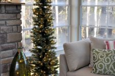 a beautiful pencil Christmas tree decorated with only lights is a stylish idea for styling a holiday space