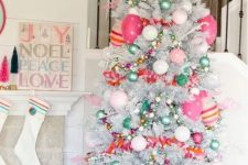 a bright and fun Christmas silver tree with pink, hot pink and green ornaments, beads and striped ornaments and stars