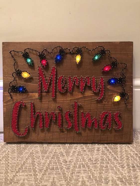 a bright holiday string art piece with letters and colorful lights done with lights is super cool