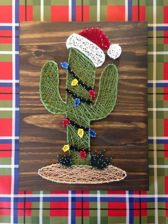 a cactus styled as a Christmas tree is a cool and catchy string art decor idea is a unique idea
