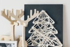 a chalkboard sign with a twine Christmas tree art for a minimalist space