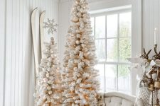 a duo of heavily flocked pencil Christmas trees in baskets will be perfect for a shabby chic space